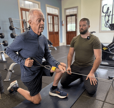 An ElderFIT trainer with a male senior working out.