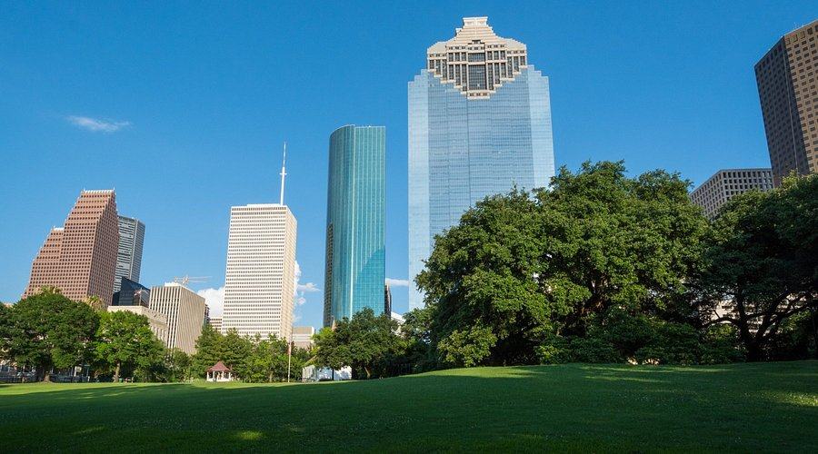 Photo of Sam Houston Park with Skyscraper in the background.