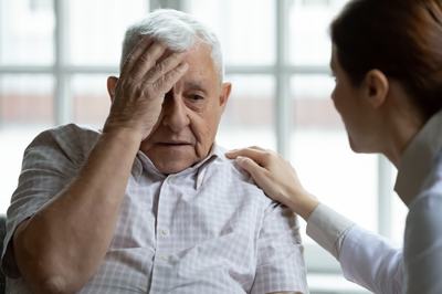 A male senior looking worried.