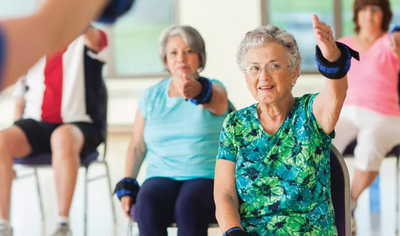 A senior with Parkinson's disease exercising in a group environment.