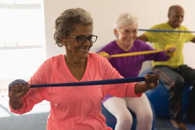 A group of seniors using resistance bands for a workout.
